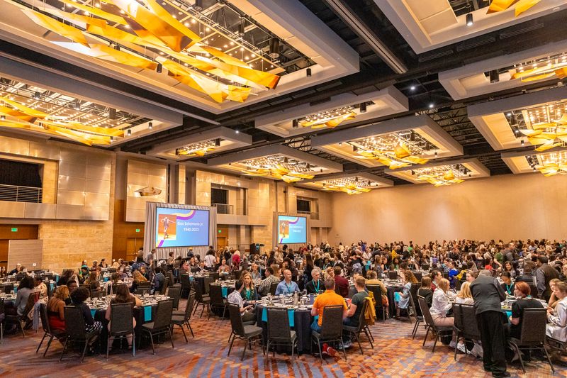 Large ballroom with seated attendees to the 2023 national conference opening reception